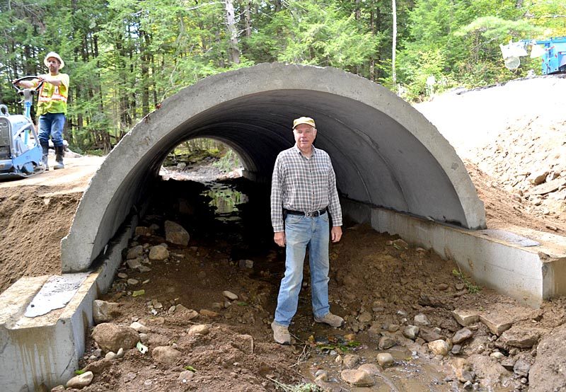 Whitefield Board of Selectmen Chairman Dennis Merrill stands at the entrance to the new Vigue Road culvert on Wednesday, Sept. 28, as crews from McGee Construction continue work. (Abigail Adams photo)