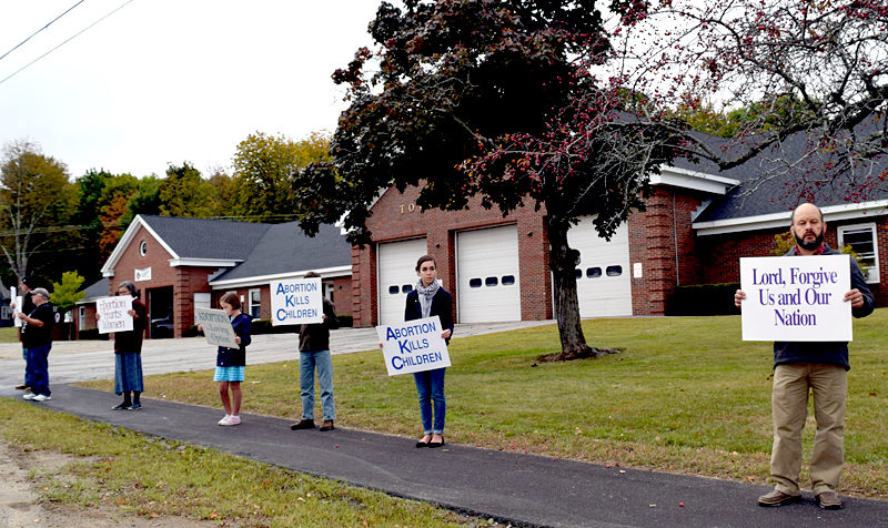 Participants in a Life Chain event hold signs reading "abortion hurts women," "abortion kills children," "adoption: the loving option," and "Lord, forgive us and our nation" in Wiscasset on Sunday, Oct. 2. (J.W. Oliver photo)