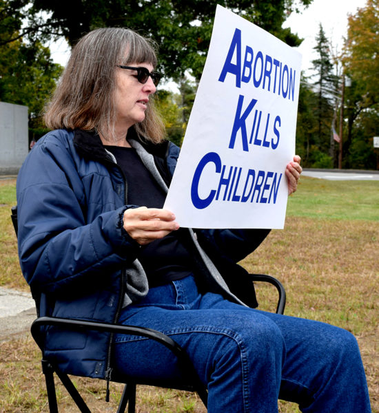 Mary Rose Pray, of Wiscasset, holds a sign reading "abortion kills children" during a Life Chain event in Wiscasset on Sunday, Oct. 2. Pray said she has been participating in Life Chain events since the early 1990s. (J.W. Oliver photo)