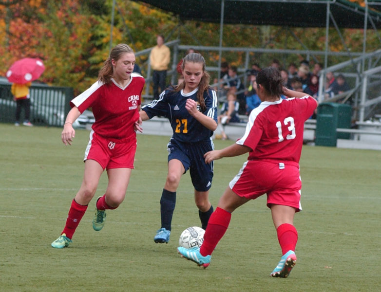 Mackenzie Emerson tries to split a pair of Camden defenders. (Carrie Reynolds photo)