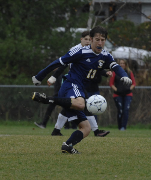 Jonathan Allard passes the ball up the field for Medomak Valley. (Paula Roberts photo)