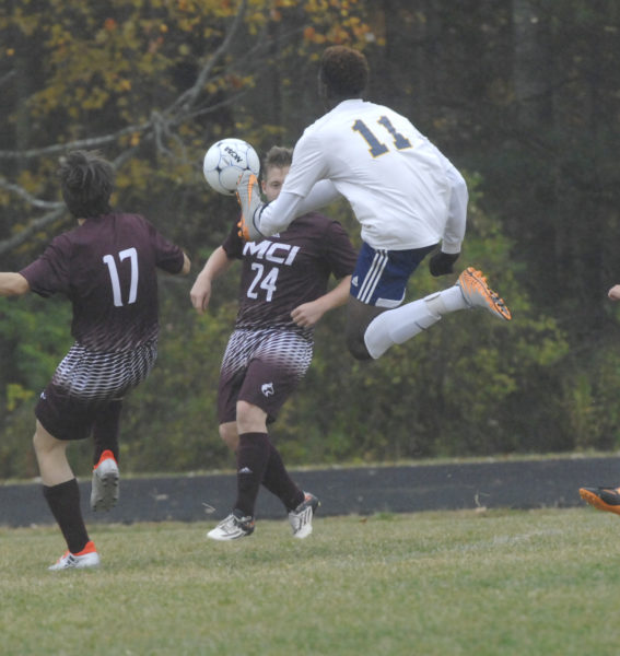 Panther Zidane McMurrin soars through the air to get a foot on the ball in Medomak's KVAC 3-0 finale win over MCI. (Paula Roberts photo)