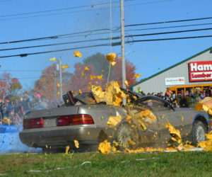 After a 145-foot drop, a pumpkin smashes into a Lexus during the final event of the 2016 Damariscotta Pumpkinfest on Monday, Oct. 10. (Maia Zewert photo)