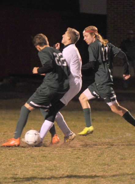 Grant Hefler gets an elbow to the midsection from Waynflete defender Miles Upton. (Paula Roberts photo)