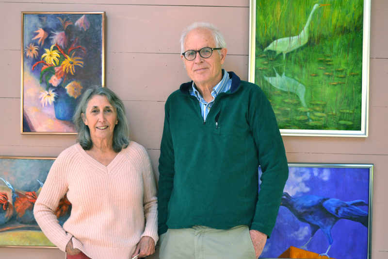 Patti Bradley and Winslow Myers stand before several of Bradley's oil paintings in their shared art studio in their Bristol home. (Christine LaPado-Breglia photo)