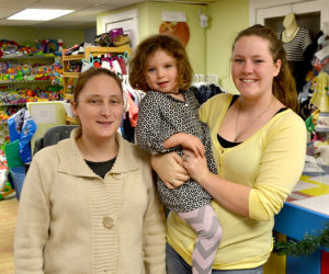 From left: Karie Manning, Annabelle Waltz, and Liz Waltz stand in The Kidz Closet at 127 Elm St. in Damariscotta. Liz Waltz purchased the business Nov. 12 and, with the help of friends, like Manning, and family, has been preparing for the store's reopening Thursday, Dec. 1. (Maia Zewert photo)