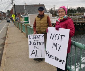 John and Carol Hartman, of Newcastle, particpate in a peaceful demonstration on the Damariscotta-Newcastle bridge Saturday, Nov. 26. "This was our first attempt at expressing our opinion loudly and proudly," Carol Hartman said. (Maia Zewert photo)