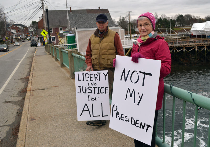 John and Carol Hartman, of Newcastle, particpate in a peaceful demonstration on the Damariscotta-Newcastle bridge Saturday, Nov. 26. "This was our first attempt at expressing our opinion loudly and proudly," Carol Hartman said. (Maia Zewert photo)