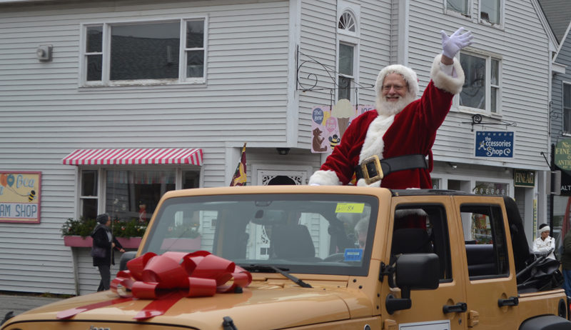 Santa Claus waves to the crowd as he makes his way down Main Street in Damariscotta on Saturday, Nov. 26. (Maia Zewert photo)