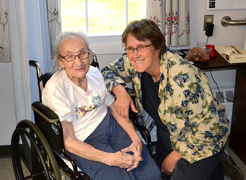 Sarah Cheiker (left) and her conservator, Linda Russell, in Cheiker's room at the Fryeburg Health and Residential Care Center in Fryeburg on Oct. 13. Cheiker has lived at the nursing home as a MaineCare patient since she was defrauded of nearly $1 million and abandoned in a cabin in Edgecomb in 2011. (Abigail Adams photo)