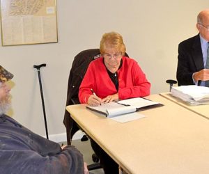 Timothy Stephenson (left) looks on as Edgecomb town attorney Bill Dale (right) speaks and Sherry Tibbetts takes minutes at the Edgecomb Board of Selectmen's Monday, Nov. 9 meeting. (Abigail W. Adams photo)