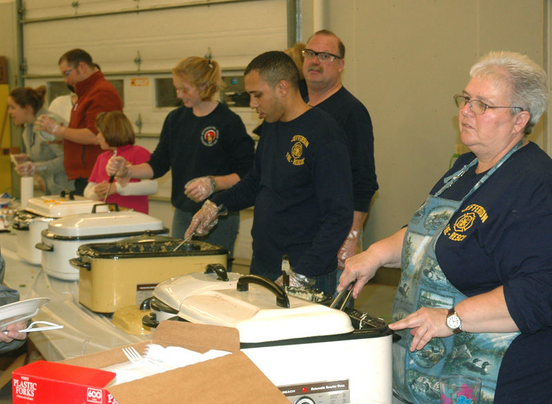 Volunteers serve dinner at the 75th anniversary open house and turkey supper at the Jefferson fire station Saturday, Nov. 12. (Alexander Violo photo)