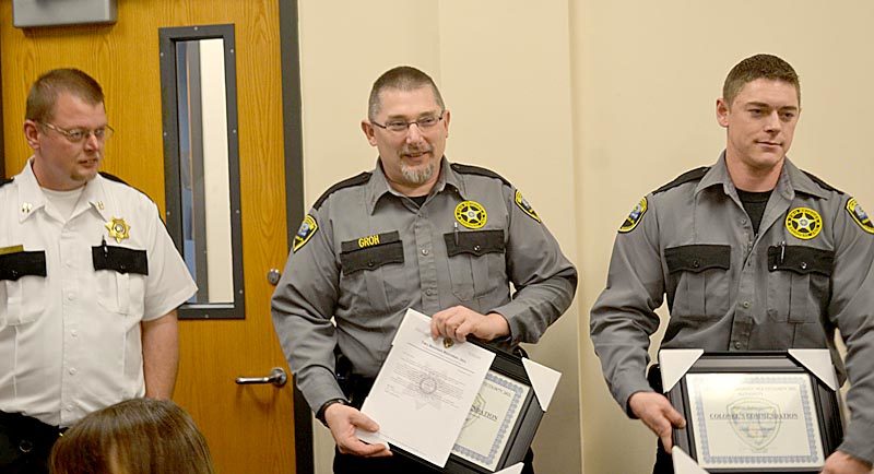 From left: Capt. James Bailey presents a Colonel's Commendation to Darryl Groh and Dylan Quimby at Two Bridges Regional Jail in Wiscasset on Wednesday, Nov. 9. The commendations recognize the officers for their role in saving an inmate's life in October. (Abigail Adams photo)