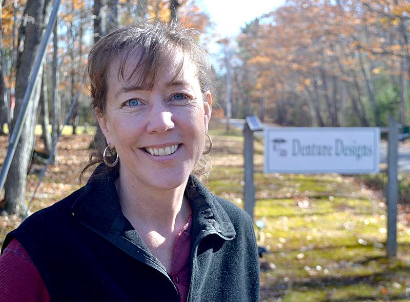 Kathryn A. Young stands in front of the sign for her practice, Denture Designs, at its new location at 40 Harrington Road in Walpole. Young will begin seeing patients at the new location Tuesday, Dec. 6. (Maia Zewert photo)