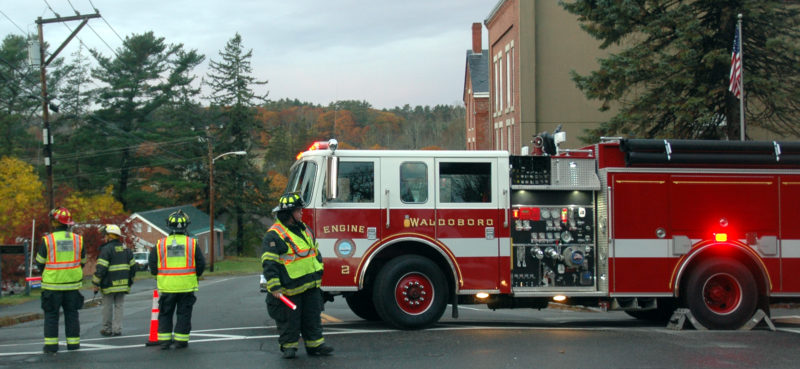 Waldoboro firefighters block Main Street during a police standoff the morning of Friday, Nov. 4. Waldoboro Fire Chief Paul Smeltzer (second from left) said they were dispatched to the area shortly after midnight. (Alexander Violo photo)