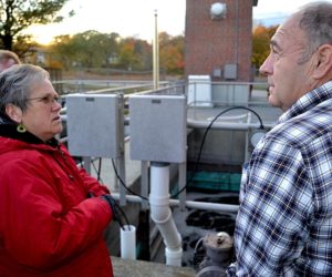 Wiscasset Selectman Judy Flanagan (left) and Wiscasset Wastewater Treatment Plant Superintendent Buck Rines stand in front of an aeration tank on Monday, Oct. 24. The tank was the subject of a problem at the plant that may result in a fine from the Maine Department of Environmental Protection. (Abigail Adams photo)