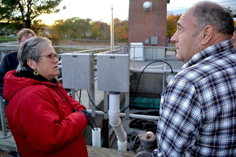 Wiscasset Selectman Judy Flanagan (left) and Wiscasset Wastewater Treatment Plant Superintendent Buck Rines stand in front of an aeration tank on Monday, Oct. 24. The tank was the subject of a problem at the plant that may result in a fine from the Maine Department of Environmental Protection. (Abigail Adams photo)