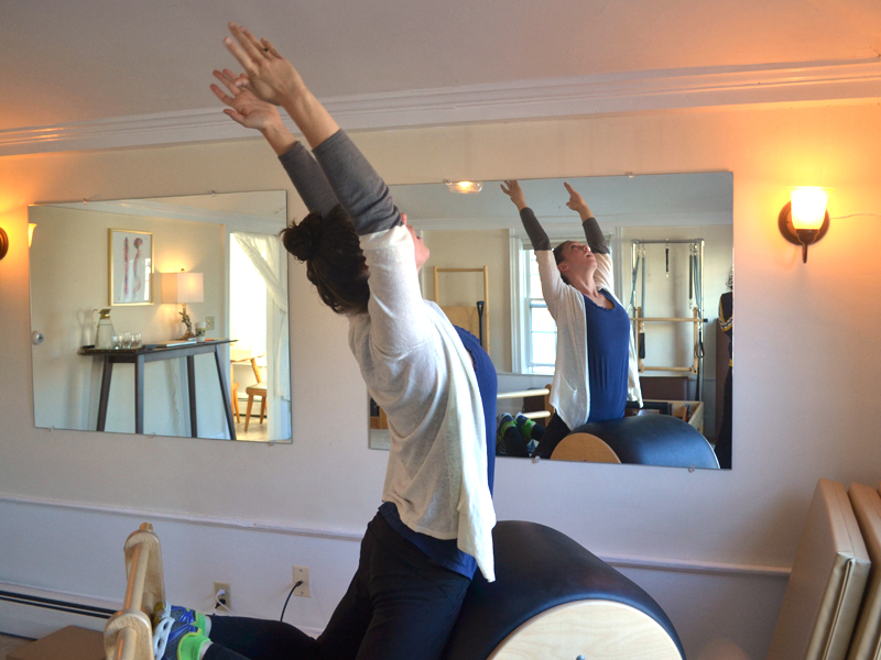 Phaelon O'Donnell demonstrates a Pilates exercise on a piece of equipment called the high barrel at her studio, Perch Pilates, in Wiscasset on Wednesday, Nov. 23. (Abigail Adams photo)