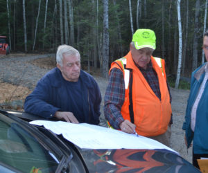 From left: Wiscasset Planning Board Chair Ray Soule, surveyor Karl Olson, and board member Lester Morse review an application for modifications to four lots in the Clark's Point Development subdivision plan during a site walk Thursday, Nov. 17. (Abigail Adams photo)