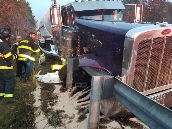 Firefighters from Woolwich and Bath work to prevent oil spilled in a collision on Route 1 from draining into the Sasanoa River the afternoon of Thursday, Nov. 10. (Photo courtesy Woolwich Fire Department)