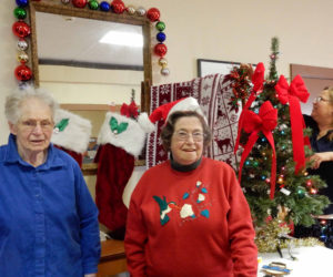 From left: Gwen Swank, Pam Meserve, and Mary Goulette prepare to deck the hall at the Alna Anchor Masonic Lodge.