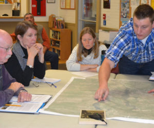 Wright-Pierce engineer Joe McLain points at a map as Bristol Dam Advisory Committee members (from left) Bill Benner, Abby Ingraham, and Claire Enterline look on during a committee meeting Wednesday, Dec. 7. (Maia Zewert photo)