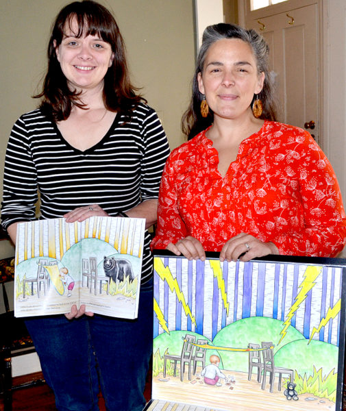 Kate Kastelein (left) holds open a copy of "Blankie's Diary" as Crystal McLain displays one of her original illustrations for the book. (Maia Zewert photo)