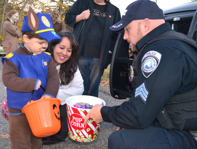 Nicholas Kupstas Jr., of Newcastle, collects candy from Sgt. Jason Warlick during a trunk-or-treat event at the Damariscotta Police Department on Halloween. The department recently received a $600 donation for the event from a Texas man after returning the man's wallet with more than $1,200 inside. (Maia Zewert photo, LCN file)