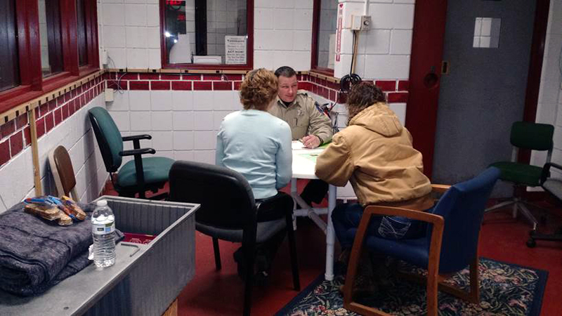 Deputy James Read of the Lincoln County Sheriff's Office demonstrates a mock intake interview with Bridges to Treatment materials and a Â“comfort kitÂ” -- food, water, and blankets for participants.