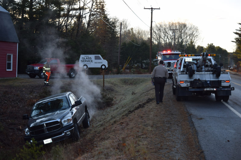The driver of a Dodge pickup truck attempts to free it from a ditch alongside Bristol Road (Route 130) in Bristol the morning of Friday, Dec. 2. Black ice was a factor in the slide-off, as well as a rollover in Dresden later the same morning, according to Lincoln County Sheriff's Office Lt. Rand Maker. (J.W. Oliver photo)