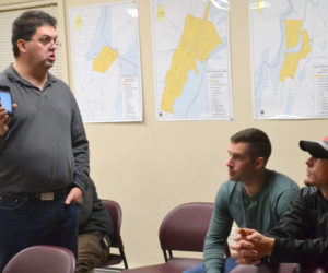 From left: Bristol firefighter Daniel MacWalters explains the I Am Responding app to Newcastle firefighters Luke Velho and Patrick Lizotte during a presentation Tuesday, Dec. 13. (Maia Zewert photo)
