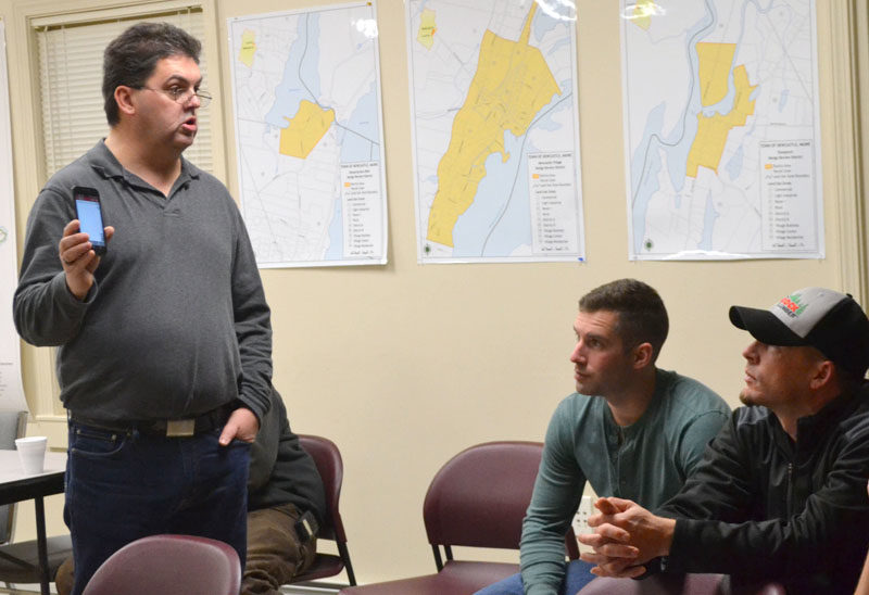 From left: Bristol firefighter Daniel MacWalters explains the I Am Responding app to Newcastle firefighters Luke Velho and Patrick Lizotte during a presentation Tuesday, Dec. 13. (Maia Zewert photo)