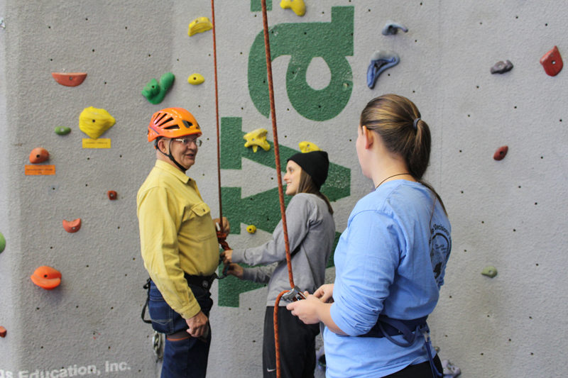 Vietnam War veteran Phil Whaley, of Port Vue, Penn., prepares to climb the indoor wall at Camp Kieve in Nobleboro with assistance from Kieve staffers Sam Copeland and Kasie Taylor. (Photo courtesy Russ Williams)