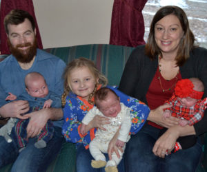 After spending 50 days in the neonatal intensive care unit in Portland, triplets (from left) Camden, Chloe, and Ainsley Merrill are home in South Bristol with parents Shane Merrill and Amanda Sykes and sister Avalee Brightman-Uhl. (Maia Zewert photo)