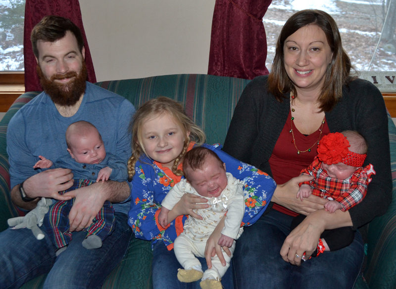 After spending 50 days in the neonatal intensive care unit in Portland, triplets (from left) Camden, Chloe, and Ainsley Merrill are home in South Bristol with parents Shane Merrill and Amanda Sykes and sister Avalee Brightman-Uhl. (Maia Zewert photo)