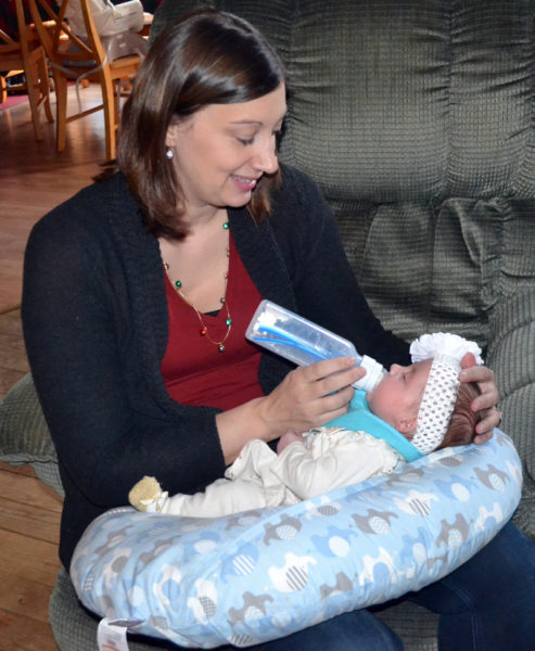 Amanda Sykes, of South Bristol, feeds her daughter, Chloe Merrill, one of three triplets born Sept. 18. (Maia Zewert photo)