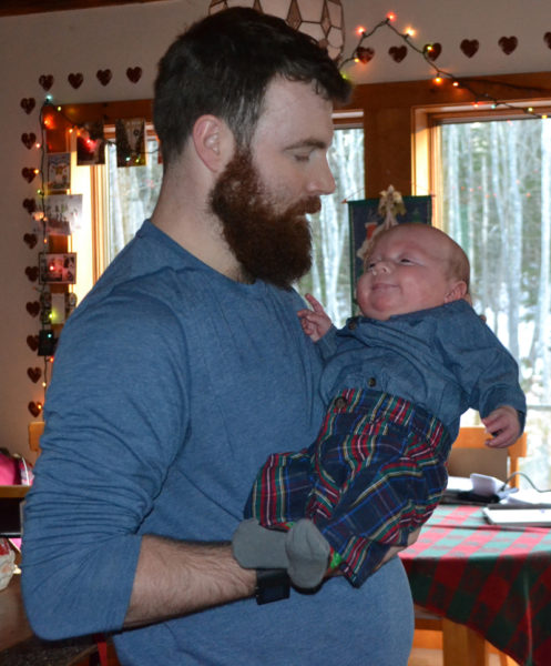 Shane Merrill holds his son, Camden Merrill, in his home in South Bristol. Merrill's fiancee, Amanda Sykes, gave birth to triplets Sept. 18. (Maia Zewert photo)