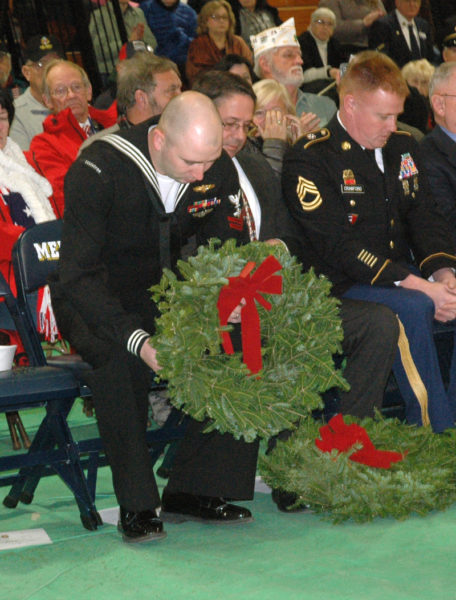 Veteran Justin Woods accepts a wreath during the Wreaths Across America ceremony at Medomak Valley High School in Waldoboro on Sunday, Dec. 11. (Alexander Violo photo)