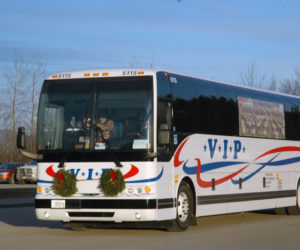 A bus carrying gold star and blue star families arrives for the Wreaths Across America ceremony at Medomak Valley High School in Waldoboro on Sunday, Dec. 11. (Alexander Violo photo)