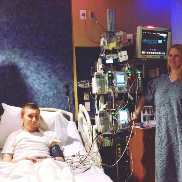 Cassie Panarese presses a button to begin a transfusion of bone marrow to her brother, Nathan Panarese, at Boston Children's Hospital on Thursday, Dec. 15. (Photo courtesy Cassie Panarese)