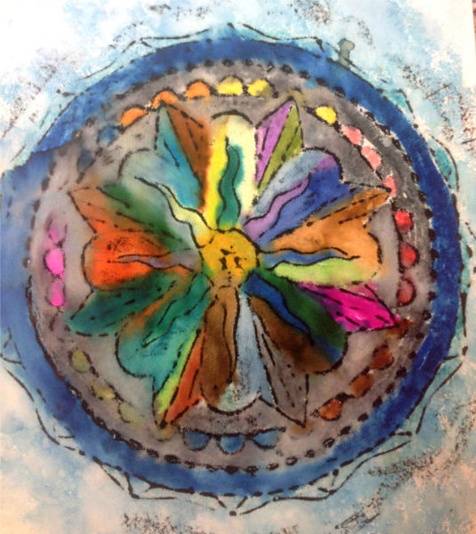 This colorful piece of artwork featuring a mandala was created by a participant in Mobius Inc.'s Creative Expressions program, which provides opportunities for people with developmental disabilities to explore a wide range of art mediums and crafts.