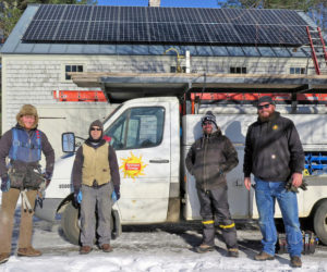 A crew from ReVision Energy poses in front of an installation on Peter Christine's barn roof. The installations add property value in addition to providing tax benefits and reducing electricity bills. (Photo courtesy Peter Christine)