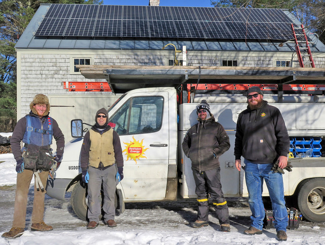 A crew from ReVision Energy poses in front of an installation on Peter Christine's barn roof. The installations add property value in addition to providing tax benefits and reducing electricity bills. (Photo courtesy Peter Christine)