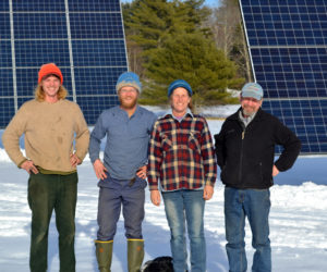 From left: Goran and Carl Johanson, Jan Goranson, and Rob Johanson stand in front of Goranson Farm's new solar installation Monday, Jan. 2. The installation will contribute to the farm's agricultural, environmental, and economic sustainability. (Abigail Adams photo)
