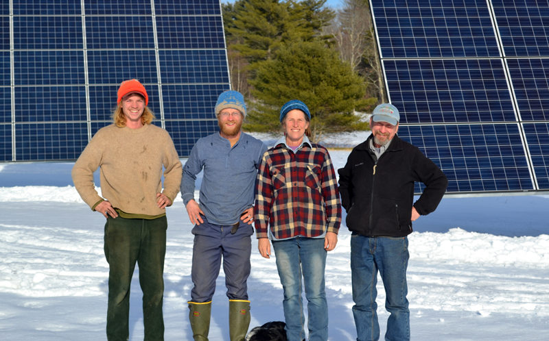 From left: Goran and Carl Johanson, Jan Goranson, and Rob Johanson stand in front of Goranson Farm's new solar installation Monday, Jan. 2. The installation will contribute to the farm's agricultural, environmental, and economic sustainability. (Abigail Adams photo)