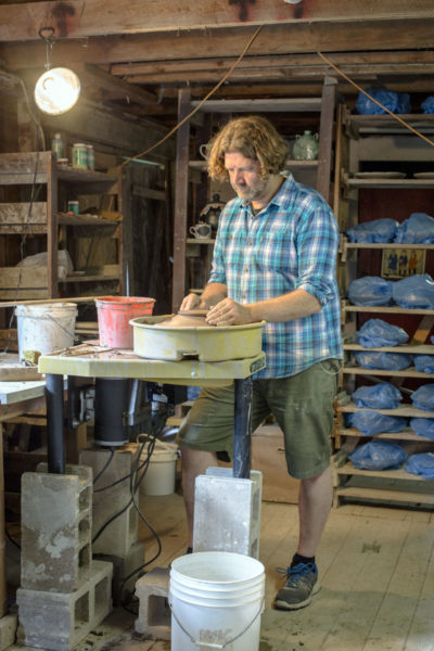 Kurt Anderson at work on one of the 500-plus plates needed for the 2017 Watershed Center for the Ceramic Arts Salad Days event, which will take place on July 8. (Photo courtesy Claire Brassil)