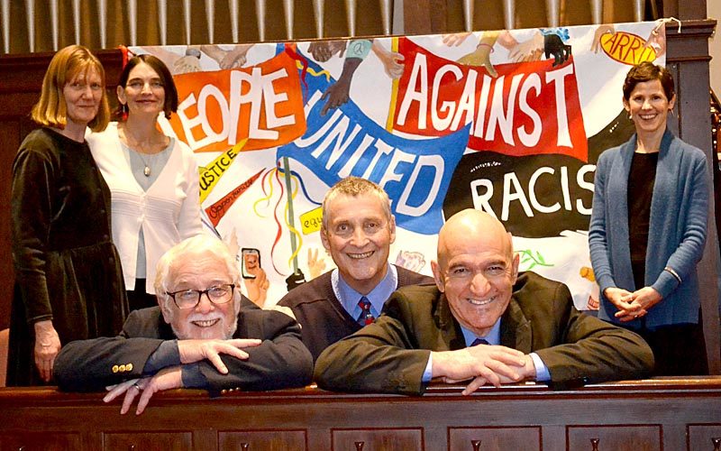 From left: Martin Luther King Jr. Day event organizers and speakers Lindy Gifford, Rev. Allison Smith, Rev. Mike Stevens, Rev. Mark Hamilton, Reza Jalali, and Rev. Erika Hewitt gather around the People United Against Racism banner at The Second Congregational Church in Newcastle on Monday, Jan. 16. (Abigail Adams photo)