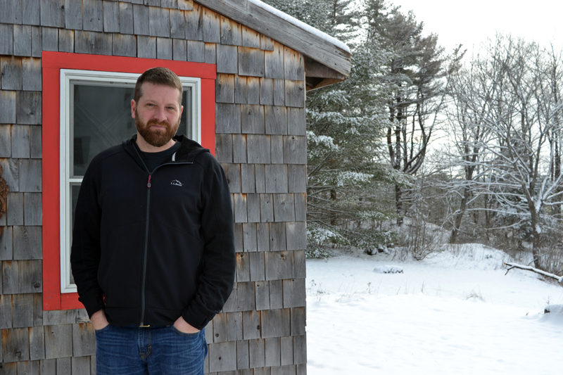 Filmmaker, composer, and musician Sumner McKane stands in front of his studio, located behind the Wiscasset home he shares with his wife and two children. (Christine LaPado-Breglia photo)