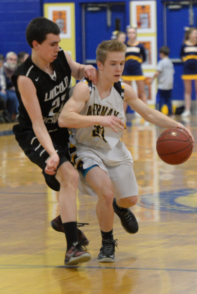 Brent Stewart brings the ball up the court for Medomak, as Lincoln Academy's Bryce York defends. (Paula Roberts photo)