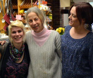 Amy Preston (center) with longtime Alna Store staff members Darci Day (left) and Allison Bailey on Monday, Feb. 27, the day before the store's sale to Ken and Jane Solorzano. (Abigail Adams photo)